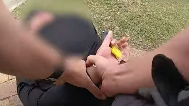 Bodycam footage shows a policeman pinning the man to the ground and cuffing him. Picture: Queensland Police