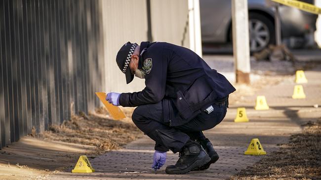 Police at the scene of the stabbing on Sunburnt St, Ingle Farm. Picture: Mike Burton