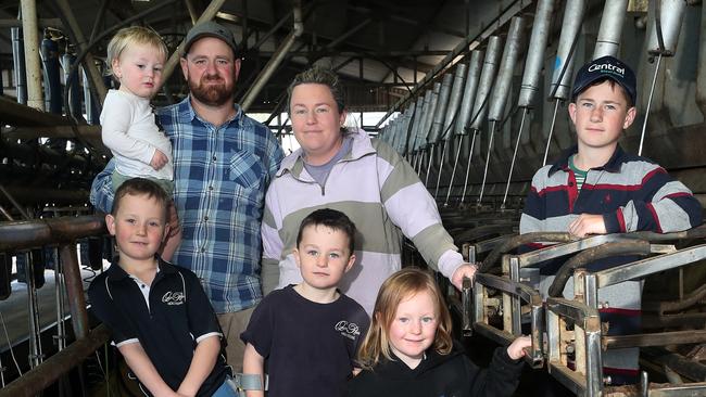 Dairy farmer Jayke Fisher, with his wife Bec, children: Cooper, 12, Max, 8, Harry, 7, (crutches), Ava, 5, Lewy, 2, dog - Allie,  Kyabram, Picture Yuri Kouzmin