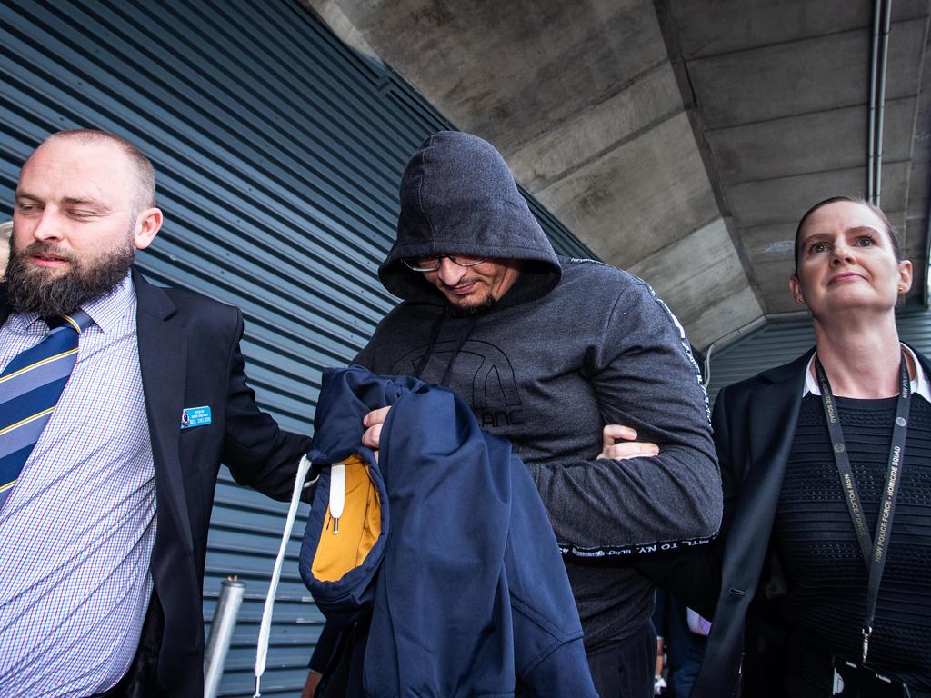 Federal police officers pictured arriving at Sydney Airport with Alex Dion. Picture: Julian Andrews