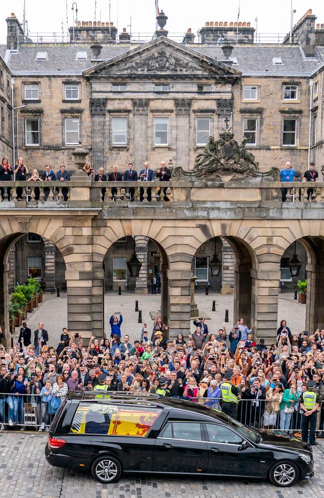 Members of the public watch the hearse carrying the coffin of the Queen. Picture: AFP.