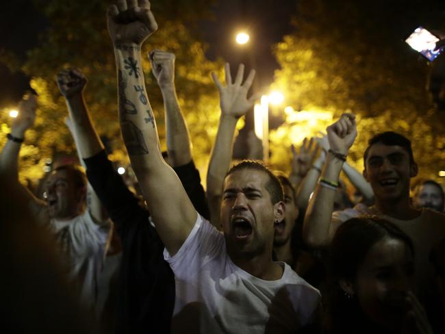 Pro-referendum supporters celebrate on the street after the closing of a polling station assigned by the Catalan government in Barcelona. Picture: Manu Fernandez/AP