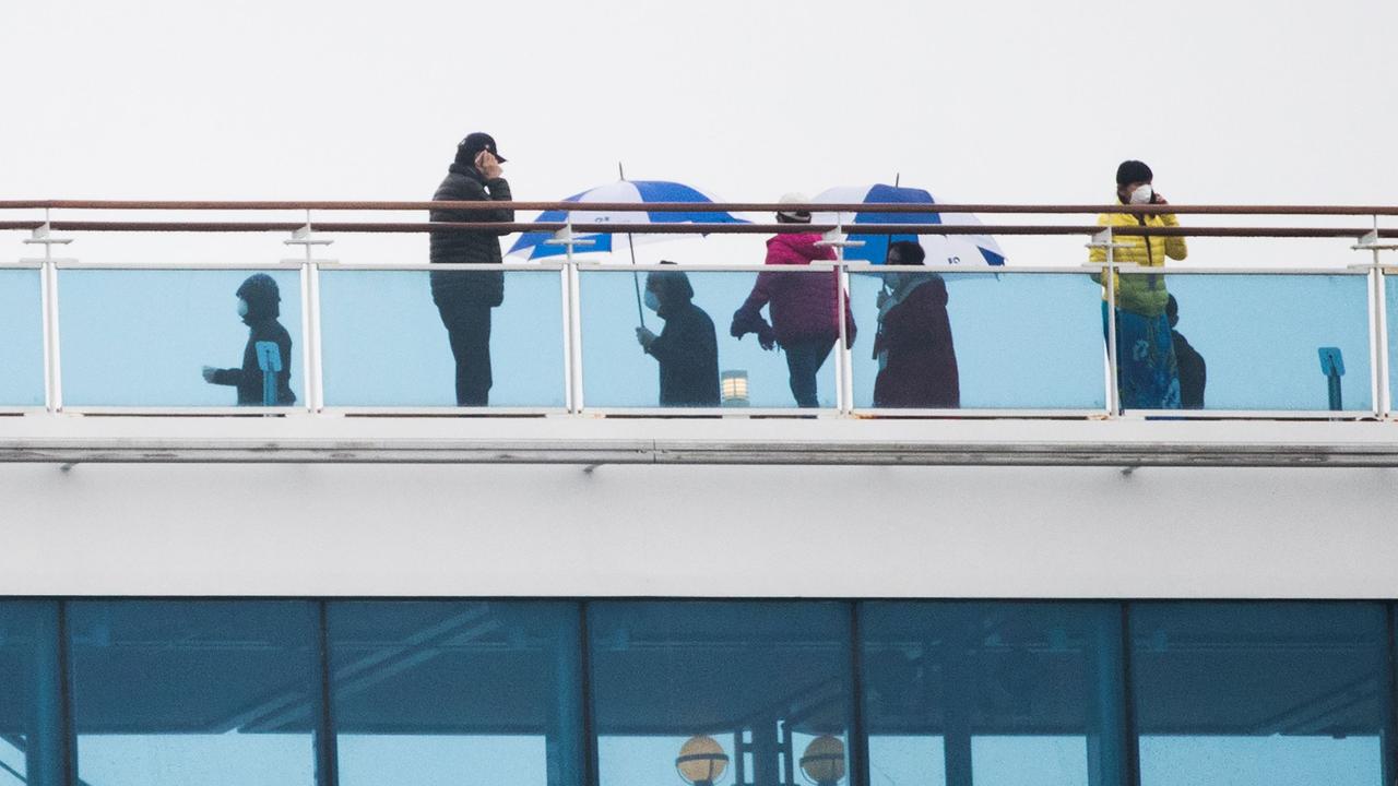 Passengers pass time on the deck of the ship. Picture: Behrouz Mehri /AFP