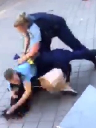 The officers subdue the girl. Picture: 9 News