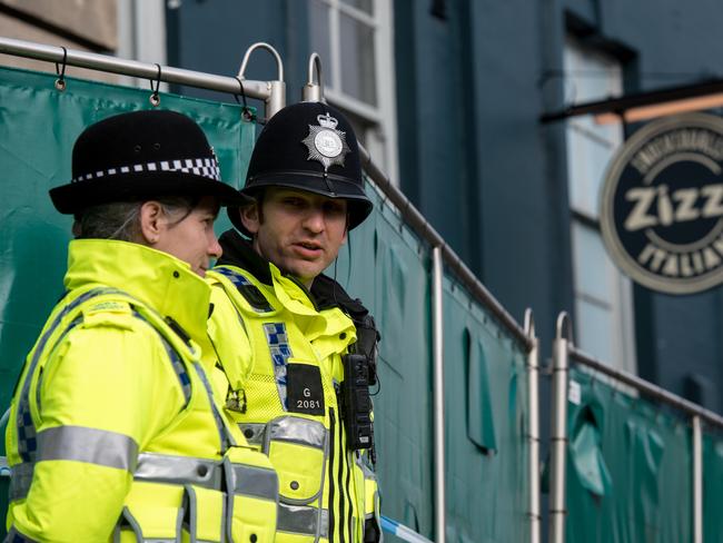 Police officers stand outside Zizzi restaurant as it remains closed as investigations continue into the poisoning. Picture: Getty