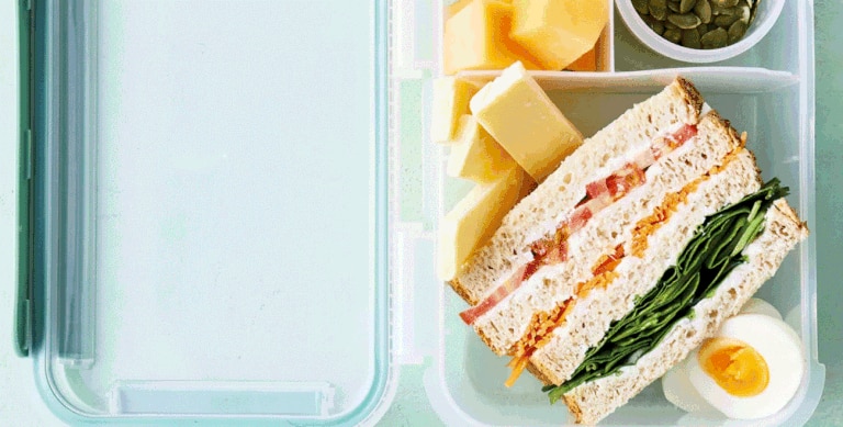 A “traffic light” sandwich using tomato, carrot and spinach, is a hit with runner Riley Day. Picture: Life Education/Woolworths