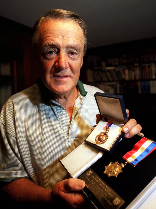 South Adelaide great Jim Deane with his Magarey Medals in 2001.