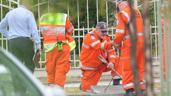 SES crews search a drain while assisting police at the scene. Picture: Andrew Henshaw