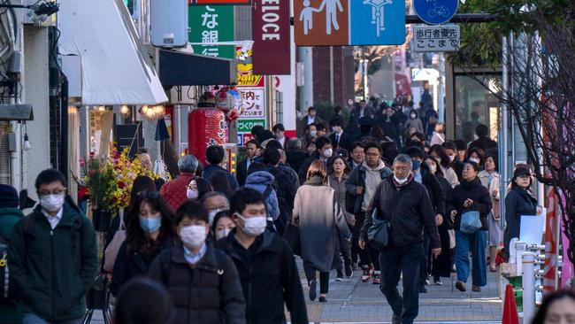 People make their way along a sidewalk in Tokyo. Picture: Kazuhiro NOGI / AFP