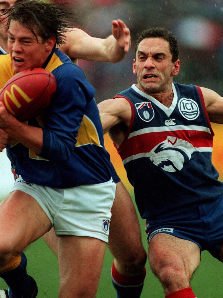 Tony Liberatore attempts to tackle Eagle Ben Cousins in Round 21, 1997.