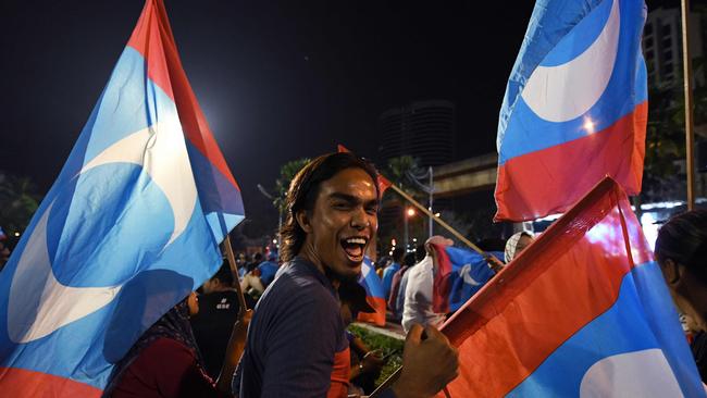 Supporters of Mahathir Mohamad celebrate in Kuala Lumpur. Picture: AFP.