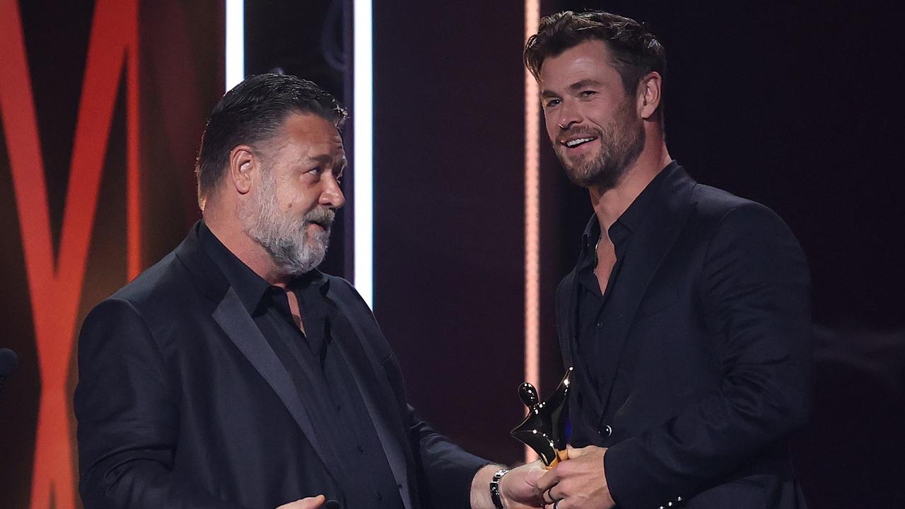 Russell Crowe hands the AACTA award to Chris Hemsworth. Picture: Brendon Thorne/Getty Images for AFI