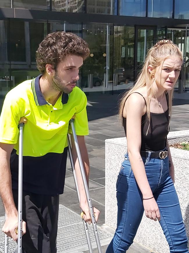 Darcy Edward Page, of Greenway, leaves the ACT Magistrates Court on crutches, accompanied by supporters after being charged with rape and child sex offences. Picture: Craig Dunlop