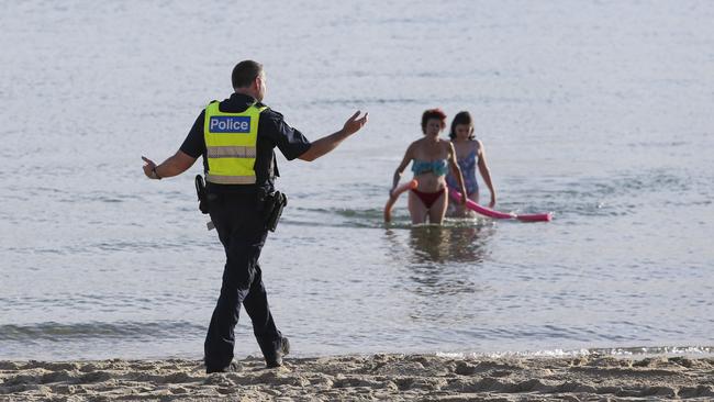 Police enforcing the closure of St Kilda beach on March 27. Picture: Wayne Taylor