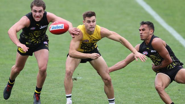 Jayden Short clears as he is tackled by Jack Ross and Sydney Stack. Picture: Michael Klein