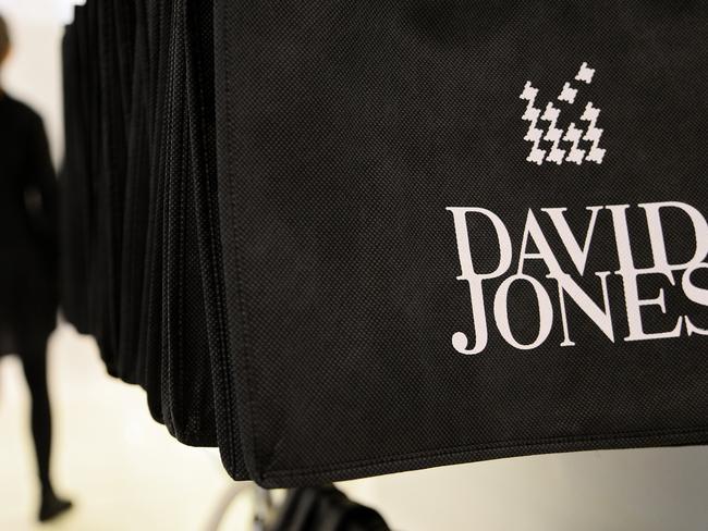 David Jones Ltd. branded shopping bags hang near a sales counter inside the company's Bourke Street store in Melbourne, Australia, on Wednesday, April 9, 2014. South Africa's Woolworths Holdings Ltd. agreed to buy Australian retailer David Jones Ltd. for A$2.15 billion ($2 billion) to expand in a market targeted by global rivals including Inditex SA and Hennes & Mauritz AB. Photographer: Carla Gottgens/Bloomberg