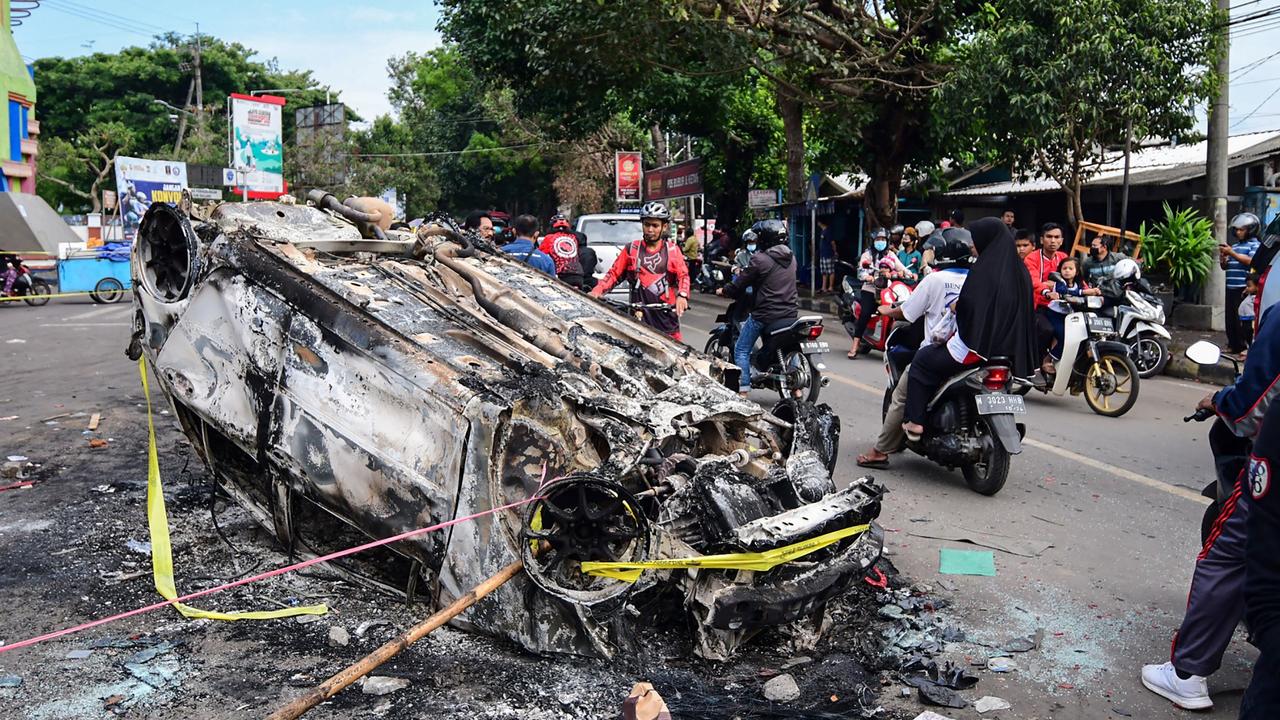 A torched vehicle outside Kanjuruhan Stadium in Malang, East Java. Photo by AFP