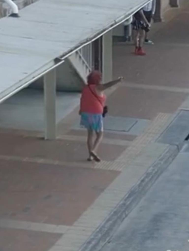 The woman points back at the camera as she nears the bus stop. Picture: Instagram