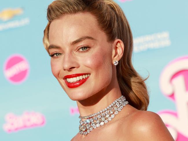 (FILES) Australian actress Margot Robbie arrives for the world premiere of "Barbie" at the Shrine Auditorium in Los Angeles, on July 9, 2023. Hollywood's pink wave has yet to crest as Warner Bros.' "Barbie" dominated for a third straight weekend in North American theaters, pushing the film's global haul past $1 billion in a first for a solo woman director, industry watcher Exhibitor Relations said August 6. The Greta Gerwig-directed blockbuster has tapped into a cultural zeitgeist: not only did it make history by hitting the billion-dollar box office milestone, it also did so faster than any film -- including those directed by men -- in Warner Bros.' 100-year history, executives there said. (Photo by Michael Tran / AFP)