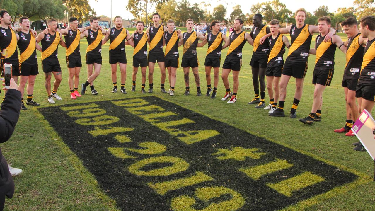 Broadview Football Club players and supporters sing the team song around a tribute to player Sam De Leonardis, who died last year, following their division two Adelaide Footy League win on Saturday, July 4 2020. Picture: Matt Oborn