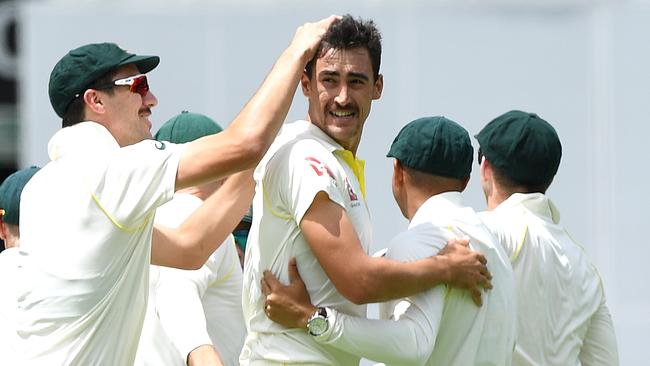 Mitchell Starc, centre, reacts after dismissing England batsman Alastair Cook. Picture: AAP.