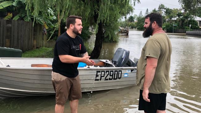 LNP candidate for Herbert Phillip Thompson helps out during Townsville floods.