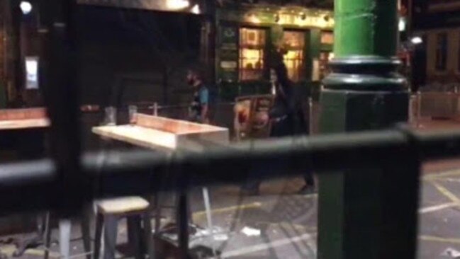 Terrorists are seen calmly walking past bars during the attacks. Picture: Daily Express