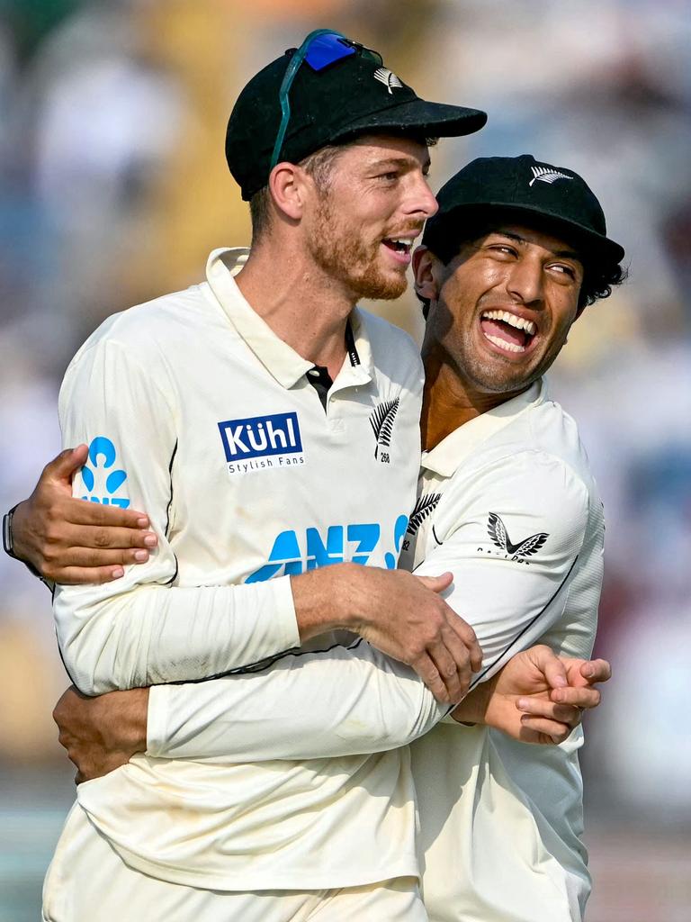 New Zealand's Mitchell Santner is embraced by Rachin Ravindra as they celebrate. (Photo by Punit PARANJPE / AFP).