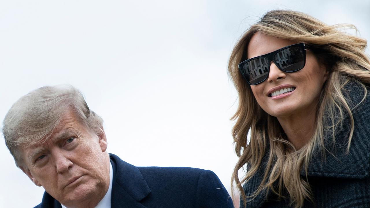 US President Donald Trump and First Lady Melania Trump walk from Marine One as they return to the White House on December 31, 2020.