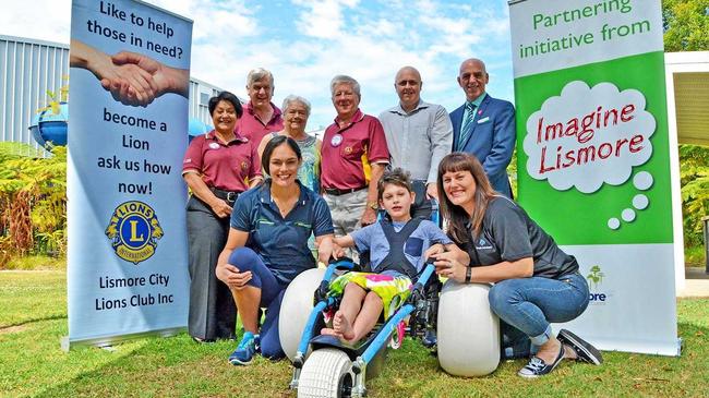 Launching the new beach wheelchair are (front) Ashton, his mum Angela Mathew of Lifestyle Solutions and Elisha Hillier from Goonellabah Sports & Aquatic Centre with (rear l-r) Lismore City Lions Club members Nancy Casson, Rod Johnston, Lola Reichelt and Sandy McLean, DAISI Executive Officer Brett Carn and Lismore's Deputy Mayor Gianpiero Battista.