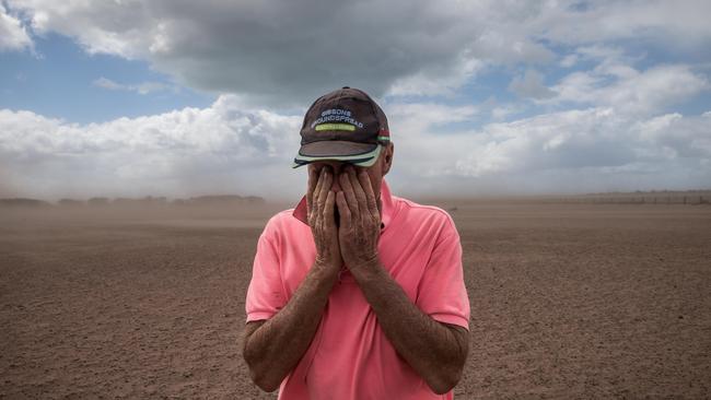 Farmer Dan Boland wipes dust from his eyes after strong winds kicked up a dust storm at his property in Darriman. Picture: Jake Nowakowski