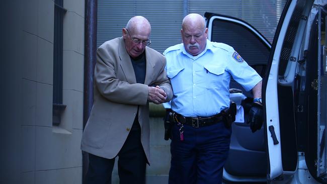 Roger Rogerson is escorted from King St court after being found guilty of the murder of student Jamie Gao. Picture: Britta Campion / The Australian.