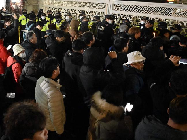 People gather in front of the main gate of the National Assembly in Seoul, South Korea on December 4, 2024, after President Yoon Suk Yeol declared emergency martial law. Picture: Jung yeon-je/AFP