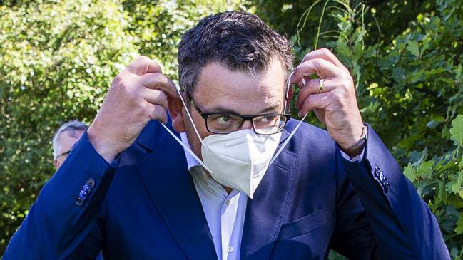 MELBOURNE, AUSTRALIA - NewsWire Photos February 17, 2022: (L-R) Victorian Premier Daniel Andrews puts on a mask after a press conference at Parliament. Picture: NCA NewsWire / Aaron Francis