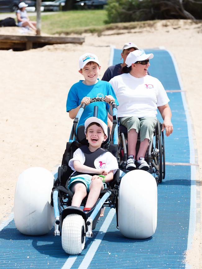 Sawyer Langan-Stark (in the chair), and brother Hudson Langan-Stark and Sauvage test out the mat. Image: Monique Harmer