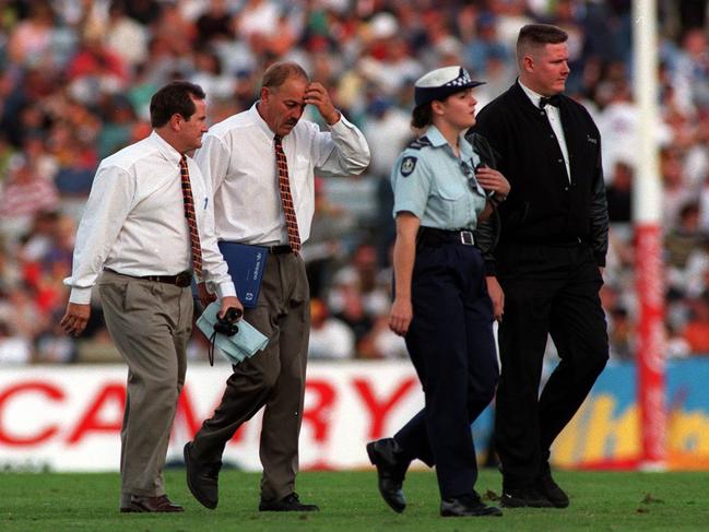 Crows coach Malcolm Blight walks off the field after the loss.