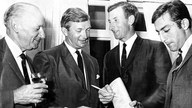 Bradman with Richie Benaud, Bill Lawry signing a cricket bat and the Nawab of Pataudi during a reception for the Indian cricket team during the fourth Test in Sydney in January 1968.