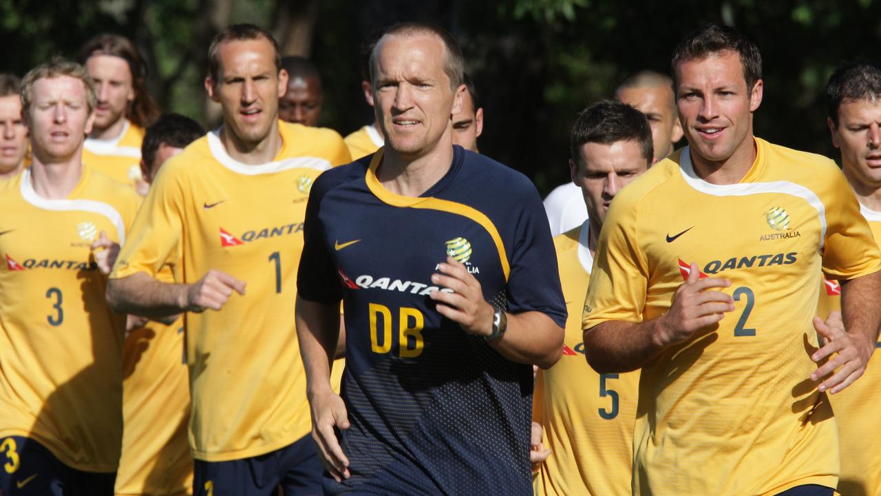 Darren Burgess during his time with the Socceroos, running ahead of Mark Schwarzer and Lucas Neill.