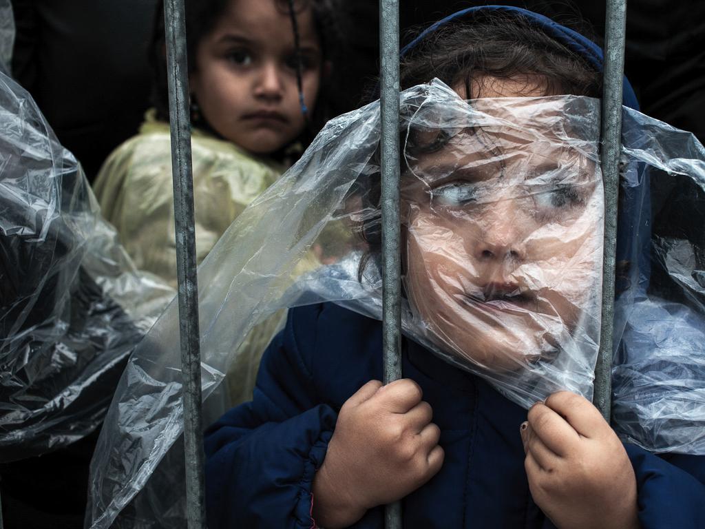 “Waiting to Register” by photographer Matic Zorman which won the first prize in the People singles category shows a child which is covered with a raincoat while she waits in line to register at a refugee camp in Presevo, Serbia, Oct. 7, 2015. (Magic Zorman, World Press Photo via AP)