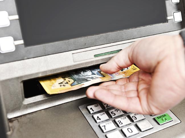 withdrawing money from an atm, collecting australian $50 notes