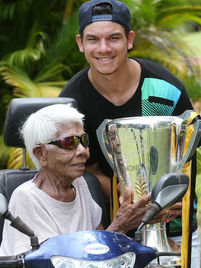 Helena Kalippa-Riol with great grandson, Richmond’s Daniel Rioli, and the 2019 AFL Premiership Cup at Pirlangimpi on Melville Island. Picture: Michael Klein