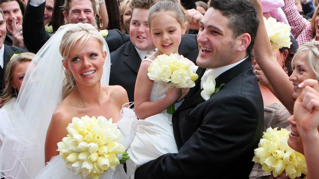 Brendan Fevola with bride Alex and a young Mia at their wedding in 2005. A grown-up Mia has hinted at a second trip down the aisle.