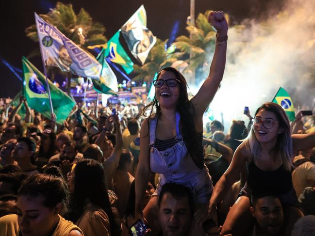 RIO DE JANEIRO, BRAZIL - OCTOBER 28: Supporters of far-right presidential candidate Jair Bolsonaro, celebrate in front of his house in Rio de Janeiro, Brazil, after he won Brazil's presidential election, on October 28, 2018 in Rio de Janeiro, Brazil. Far-right former army captain Jair Bolsonaro was elected president of Brazil on Sunday, beating leftist opponent Fernando Haddad in a runoff election after a bitter and polarized campaign. (Photo by Buda Mendes/Getty Images)