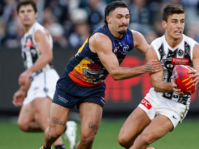 MELBOURNE, AUSTRALIA - MAY 18: Nick Daicos of the Magpies is tackled by Izak Rankine of the Crows during the 2024 AFL Round 10 match between The Collingwood Magpies and Kuwarna (Adelaide Crows) at The Melbourne Cricket Ground on May 18, 2024 in Melbourne, Australia. (Photo by Dylan Burns/AFL Photos via Getty Images)