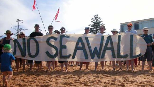 Narrabeen and Collaroy residents hold signs and protest their opposition towards the sea wall extension plans in November 2012