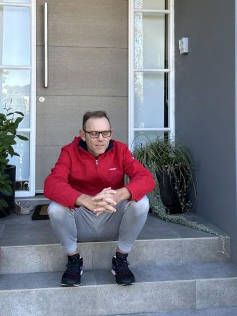 Mike Arnold sitting on the steps of a Sydney rental property that was not paid for.