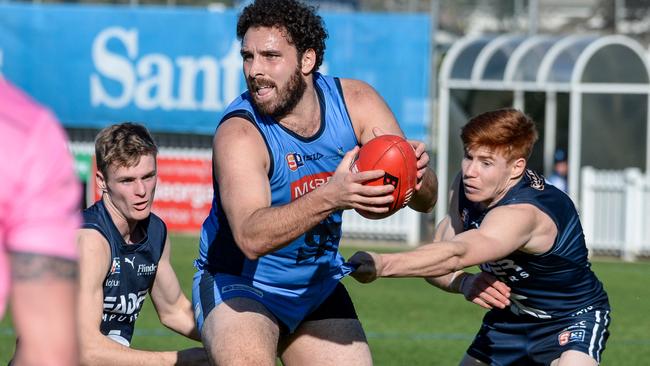 Sturt’s Abe Davis tries to evade the tackle of Panther Joey Haines at Unley Oval. Picture: Brenton Edwards.