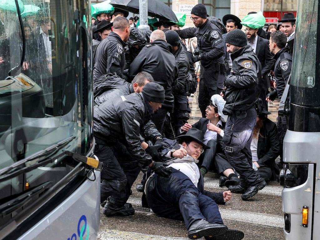 Israeli police attempt to disperse Ultra-Orthodox Jewish protesters in Jerusalem, who are opposing their draft into the armed forces amid escalating tensions in Gaza. Picture: Ahmad Gharabli/AFP