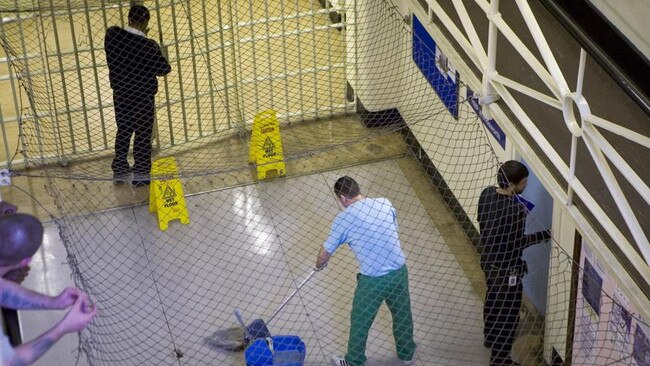 A prisoner on wing cleaning duties in HMP Wandsworth.