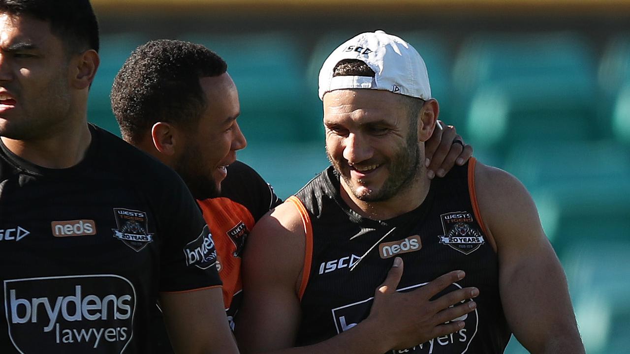 Robbie Farah is all smiles with Moses Mbye during Wests Tigers training. Picture: Brett Costello